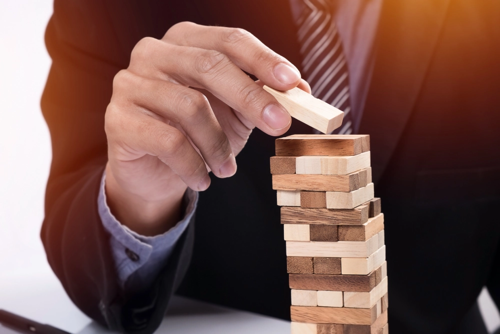 planning-risk-strategy-business-concept-businessman-gambling-placing-wooden-block-tower